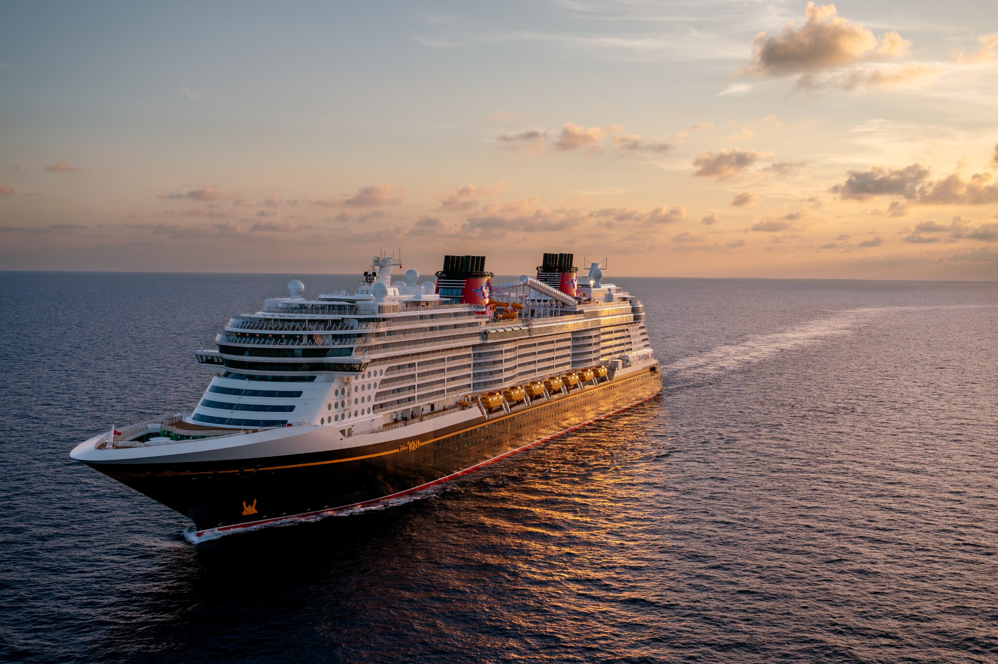 Disney Wish sailing at sunset